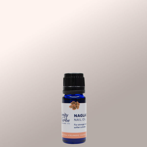 Bottle of Naglaolía Nail Oil on a light gray background